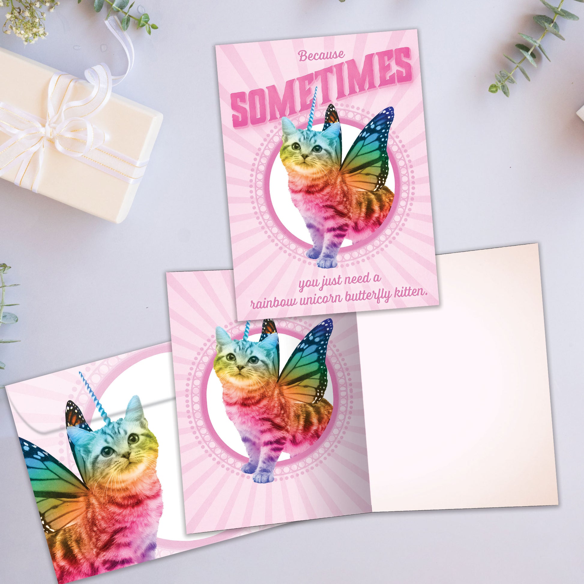 Front and inside view of an All Occasion greeting card showcasing a unicorn kitten with butterfly wings and rainbow colours, with a matching envelope.