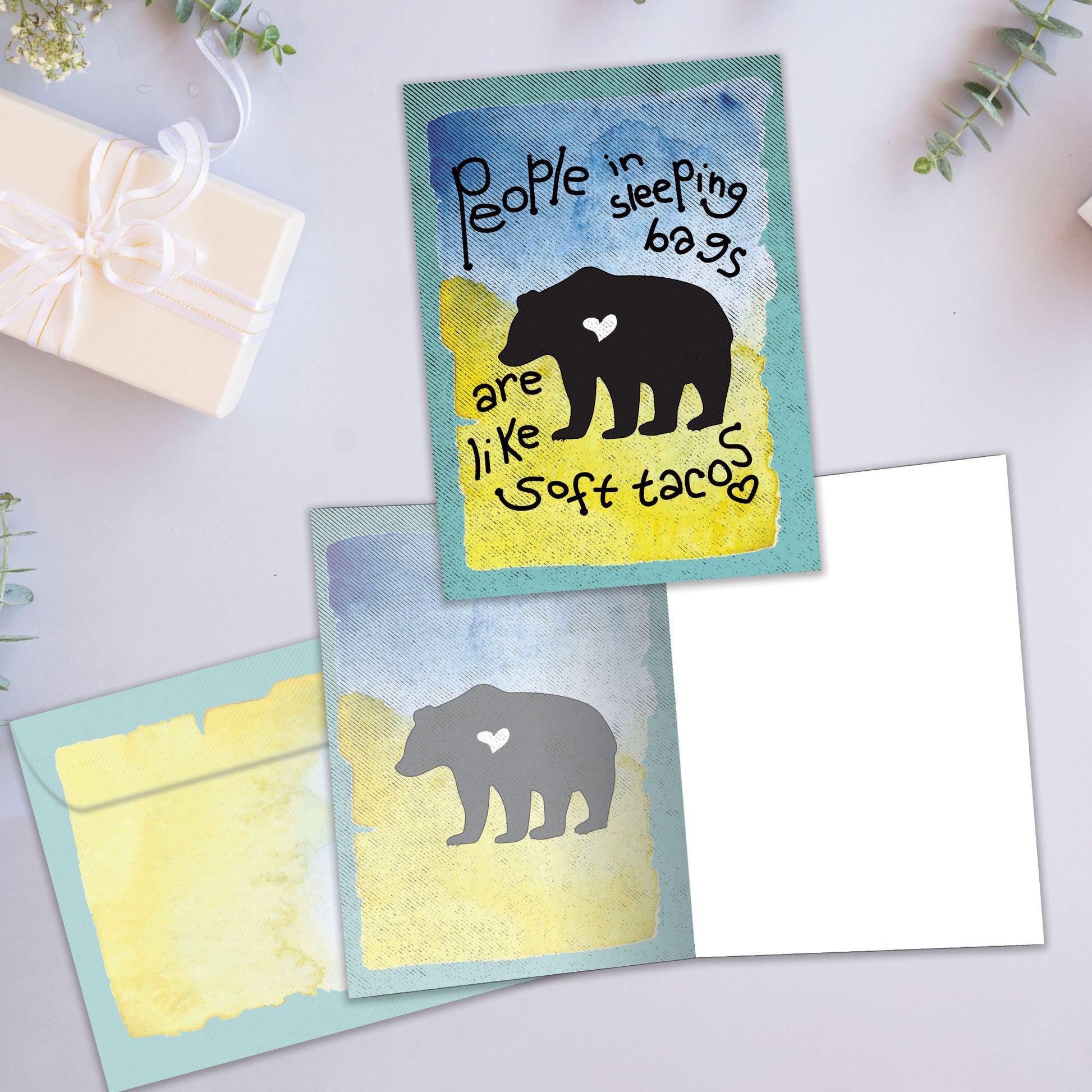 Front and inside view of an All Occasion greeting card showcasing a bear silhouette on the cover with a message, with a matching envelope.