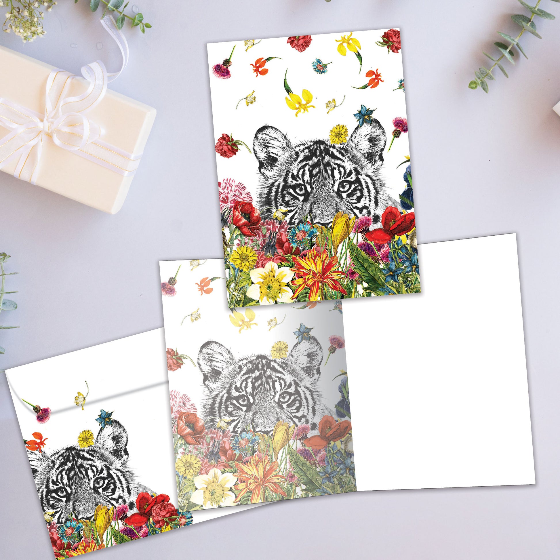 Front and inside view of an All Occasion greeting card showcasing a tiger surrounded by flowers, with a matching envelope."