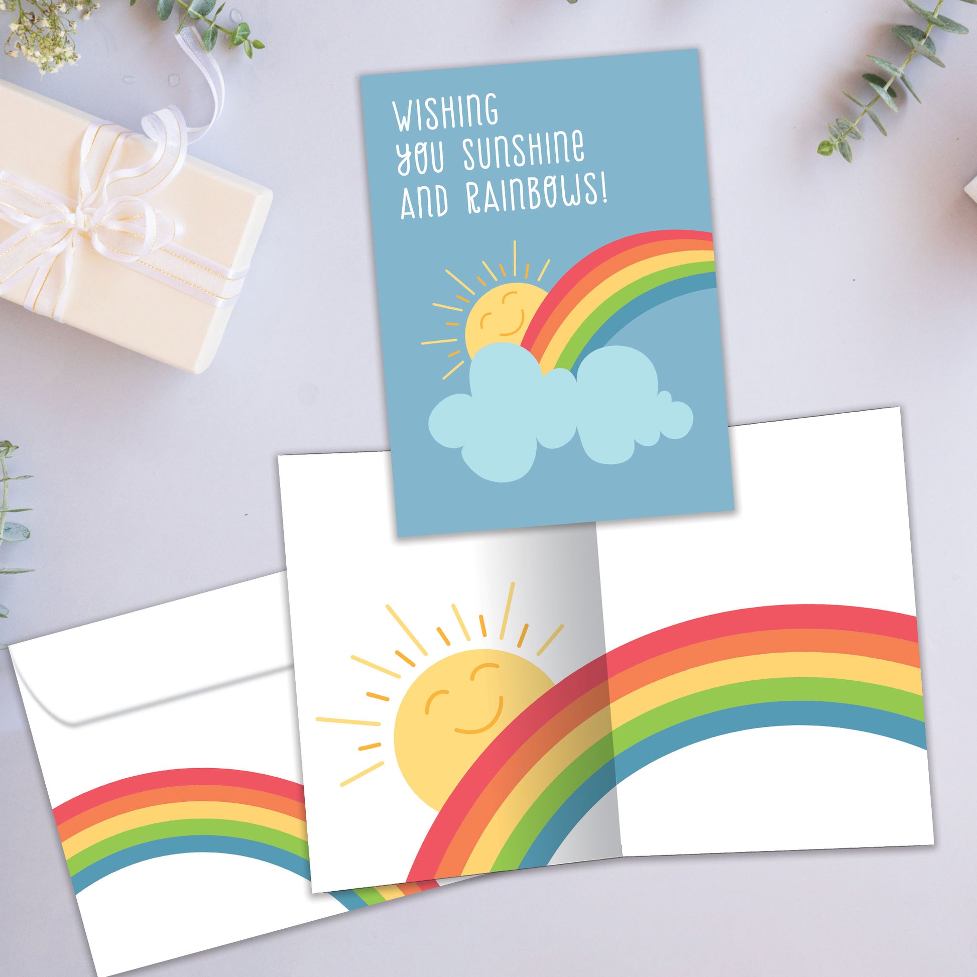 Front and inside view of an All Occasion greeting card showcasing a sun and rainbow illustration with a nice message, with a matching envelope.