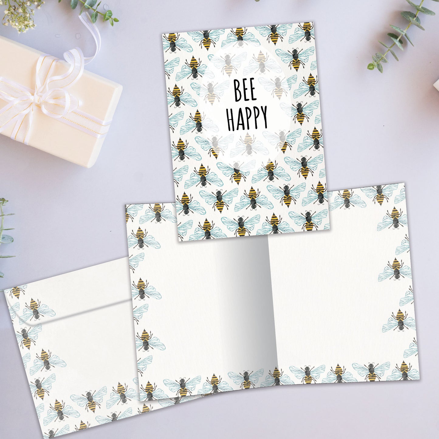 Front and inside view of an All Occasion greeting card showcasing bees and the message 'bee happy,' with a matching envelope.