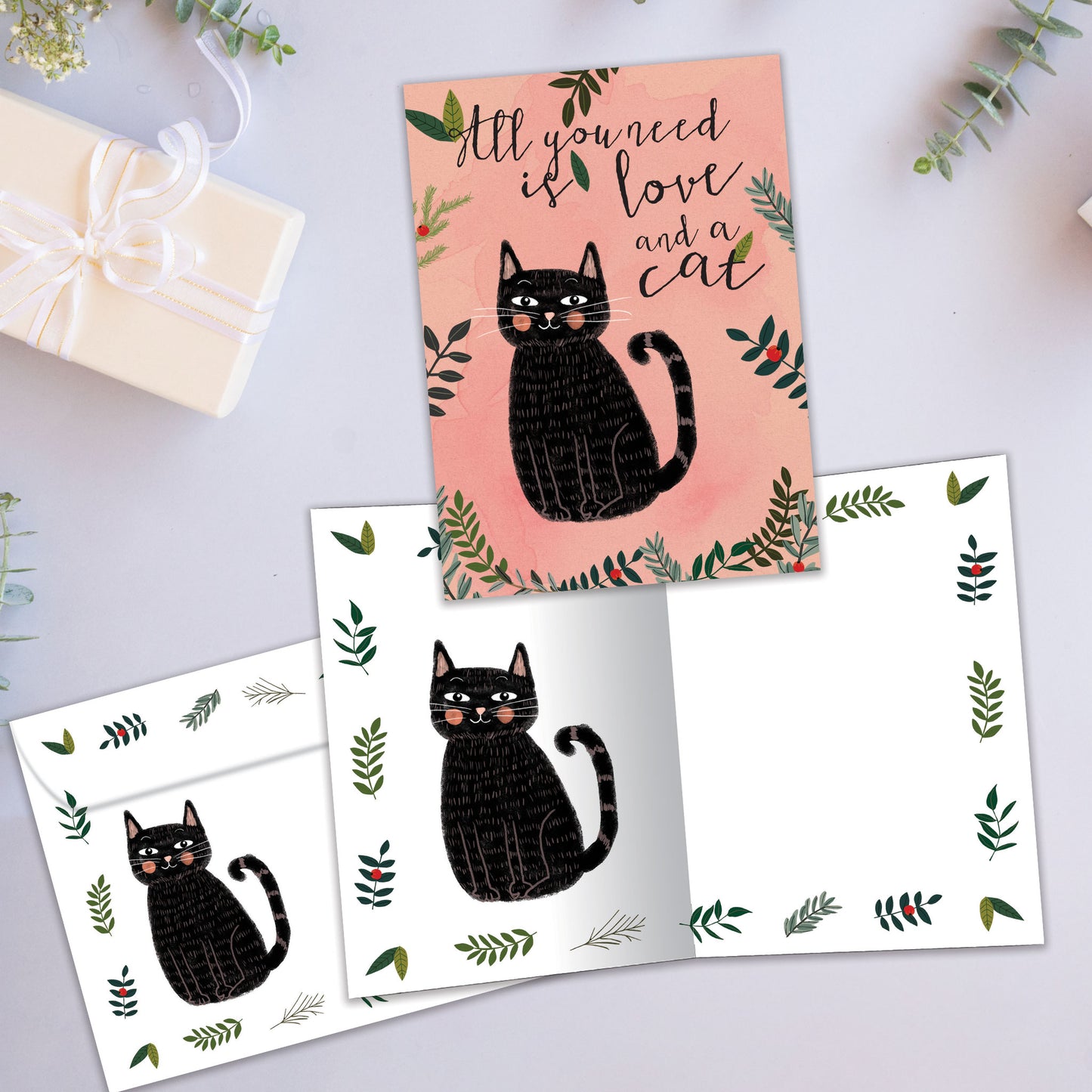 Front and inside view of an All Occasion greeting card showcasing a cat and the message 'all you need is love and a cat,' with a matching envelope.