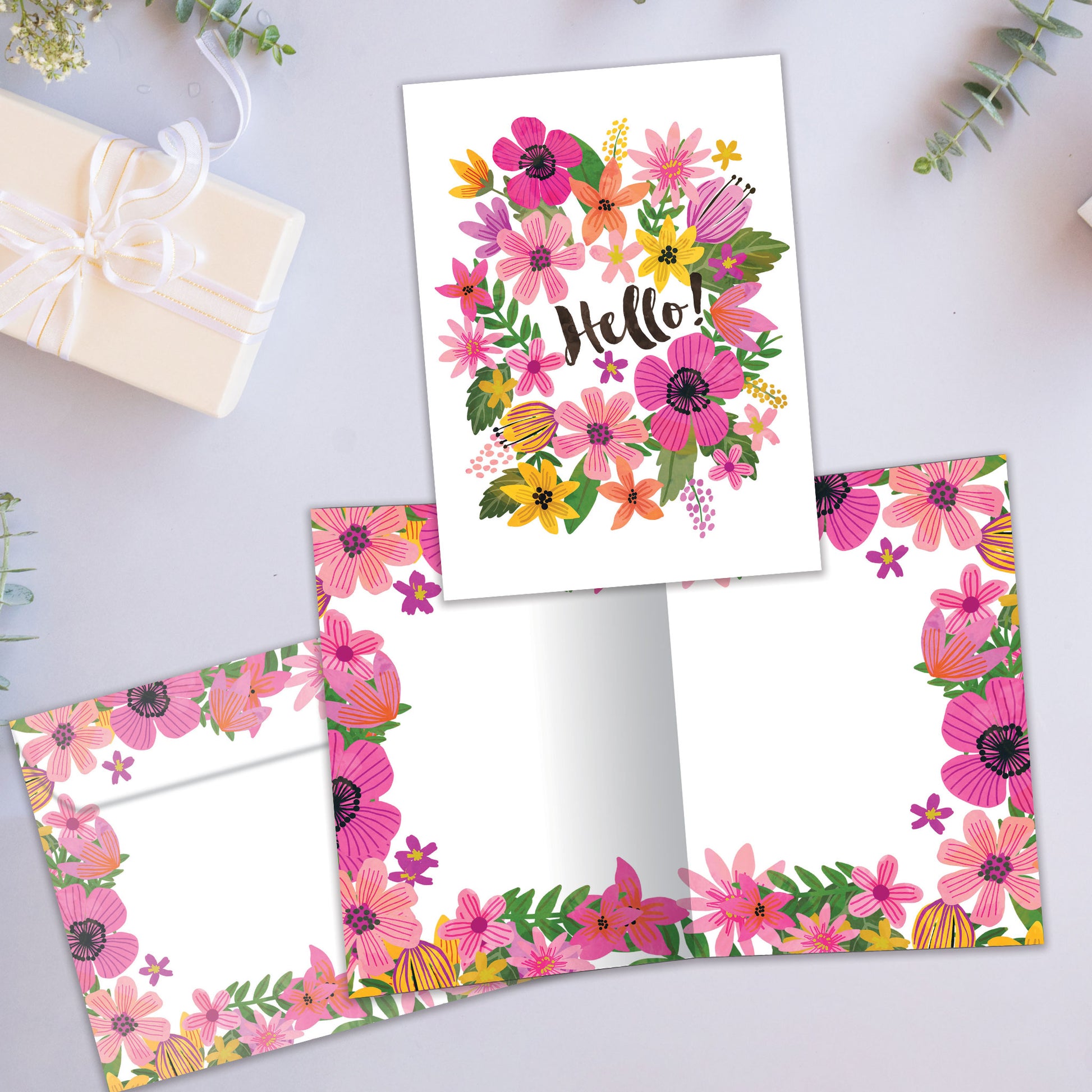Front and inside view of an All Occasion greeting card showcasing colourful flowers and the message 'Hello!,' with a matching envelope.