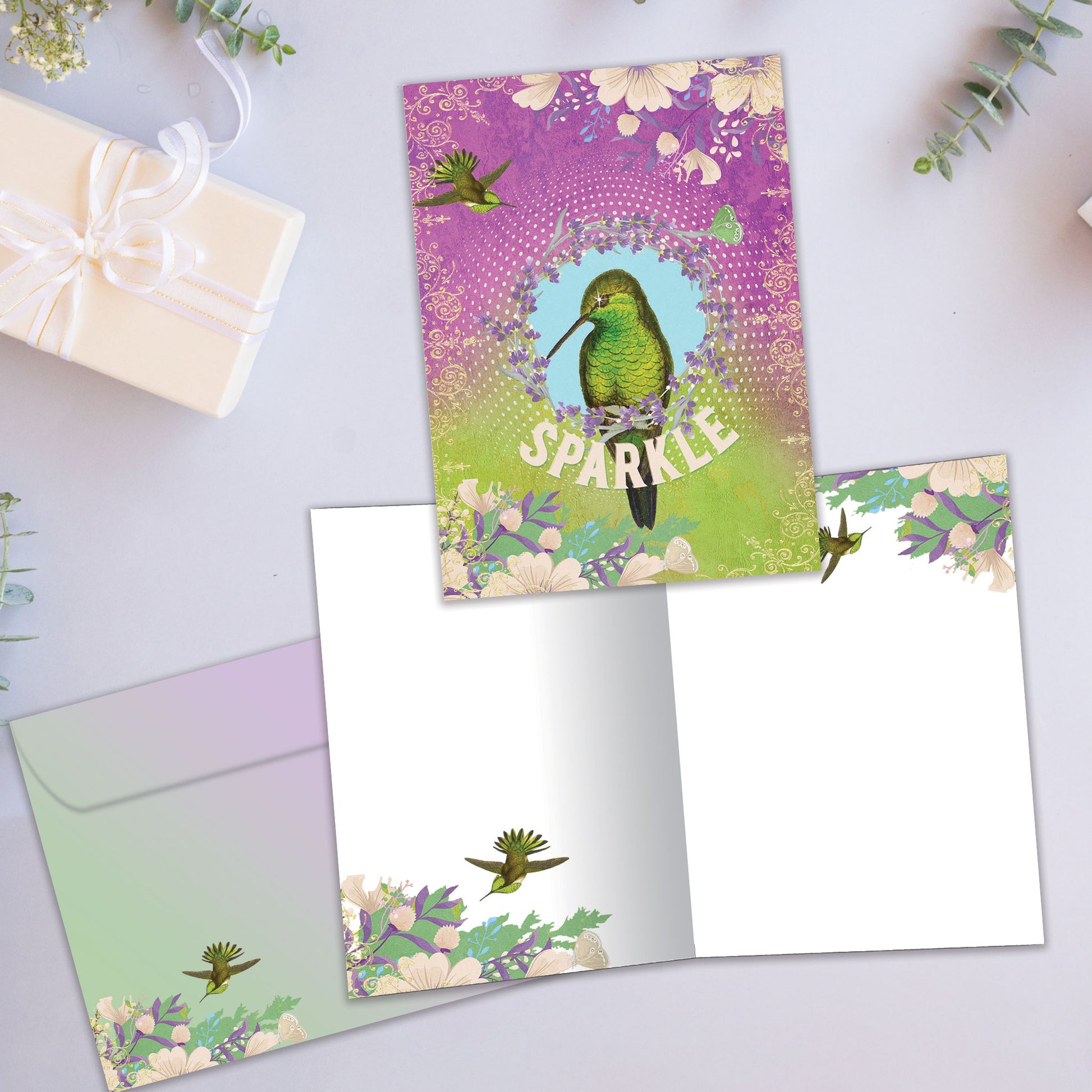 Front and inside view of an All Occasion greeting card showcasing a bird illustration and the word 'sparkle,' with a matching envelope.