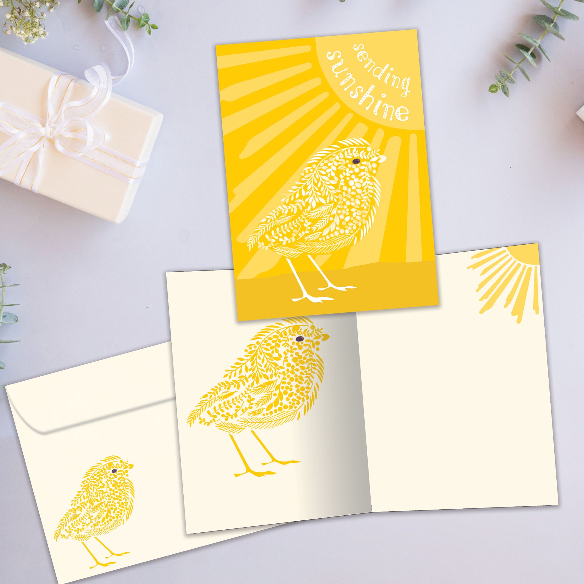 Front and inside view of an All Occasion greeting card showcasing a bird, the sun, and the message 'sending sunshine,' with a matching envelope.