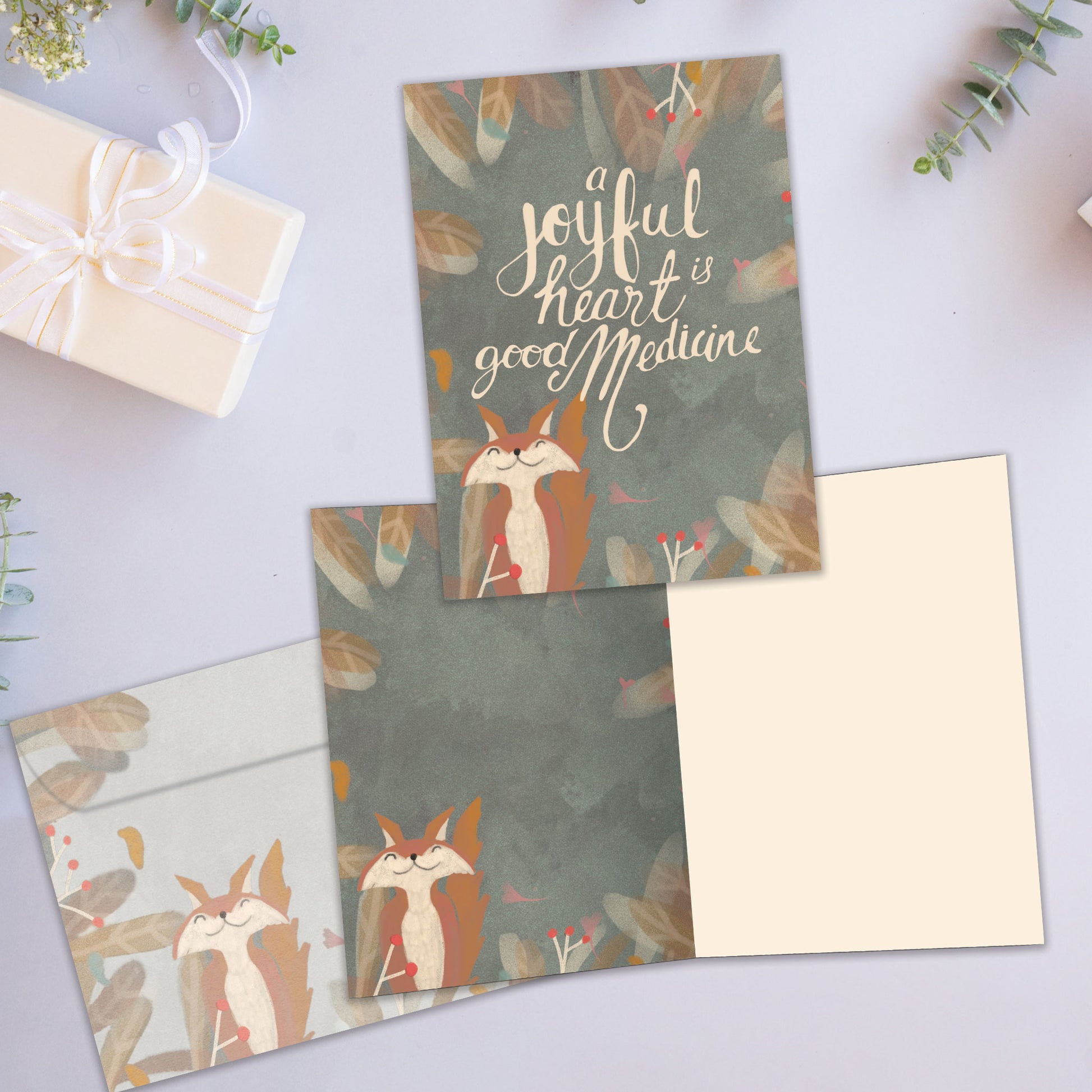 Front and inside view of an All Occasion greeting card showcasing a happy fox and a joyful message, with a matching envelope.