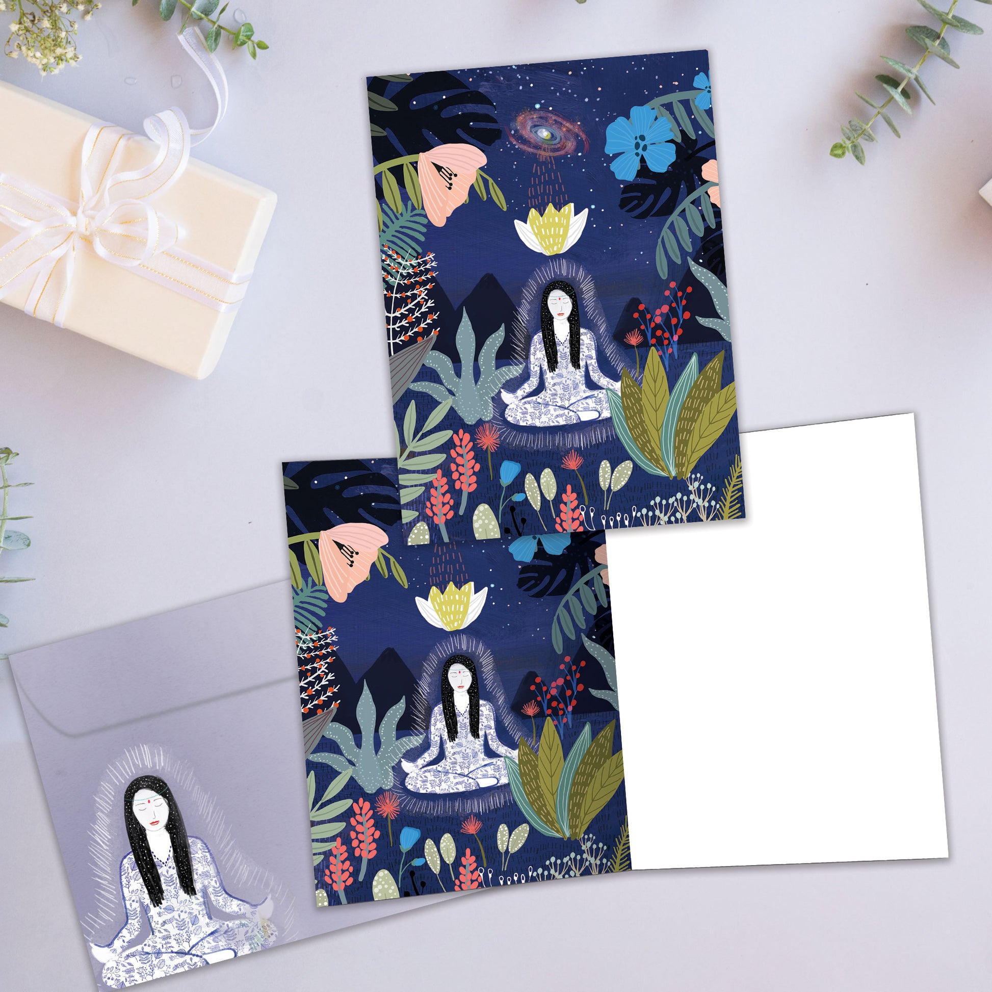 Front and inside view of an All Occasion greeting card showcasing a woman meditating in a garden under the stars, with a matching envelope.