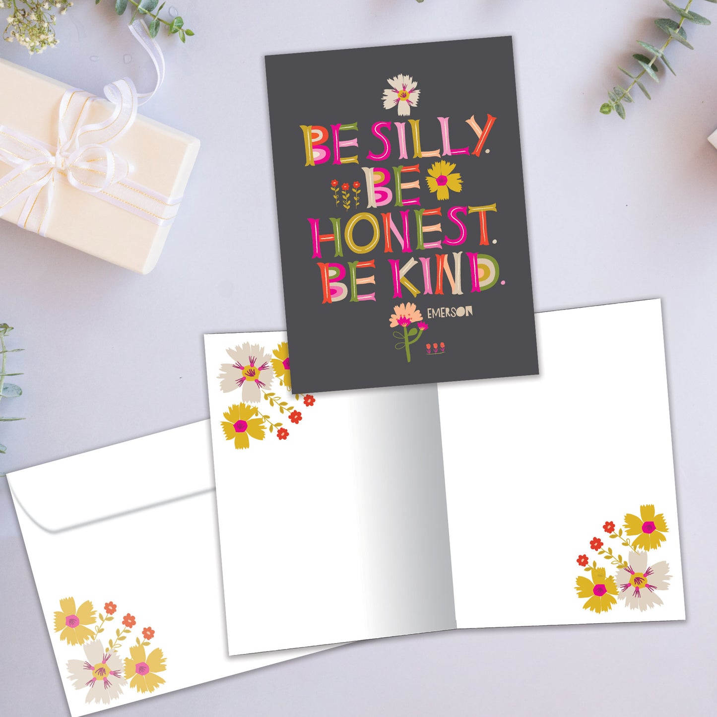 Front and inside view of an All Occasion greeting card showcasing a floral design and the message 'Be silly. Be Honest. Be kind.,' with a matching envelope.