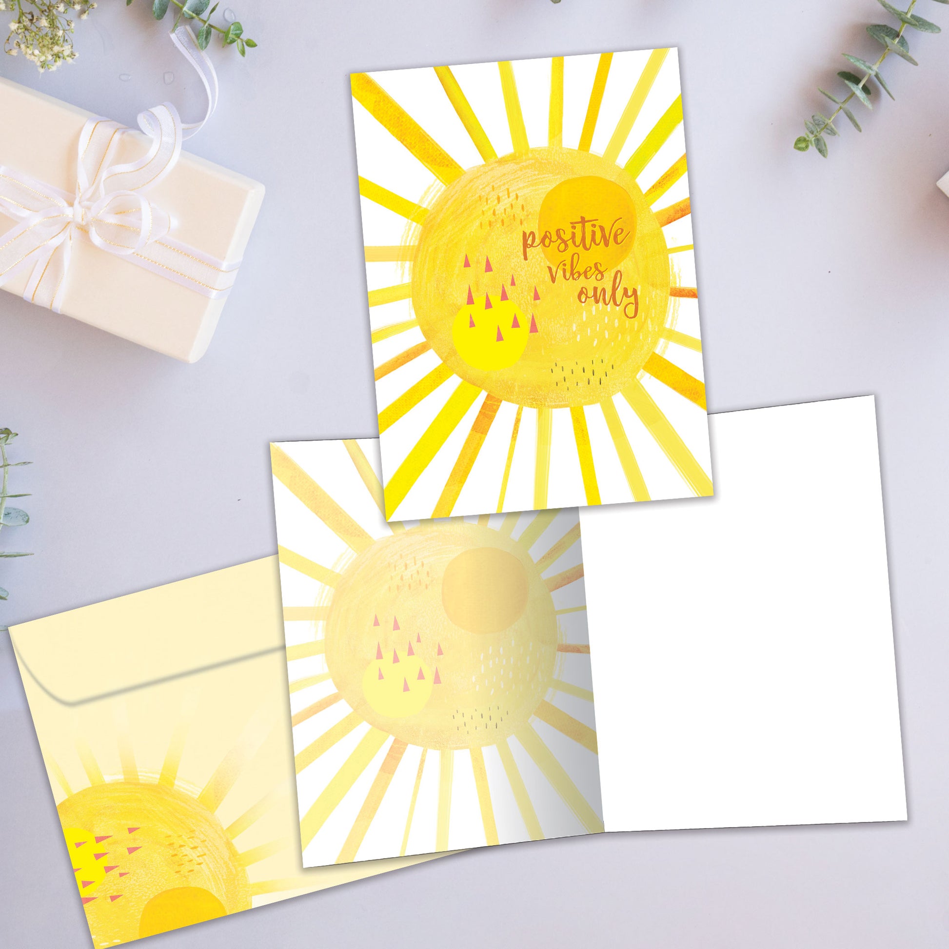 Front and inside view of an All Occasion greeting card showcasing a bright yellow sunshine illustration with the words 'positive vibes only,' with a matching envelope.