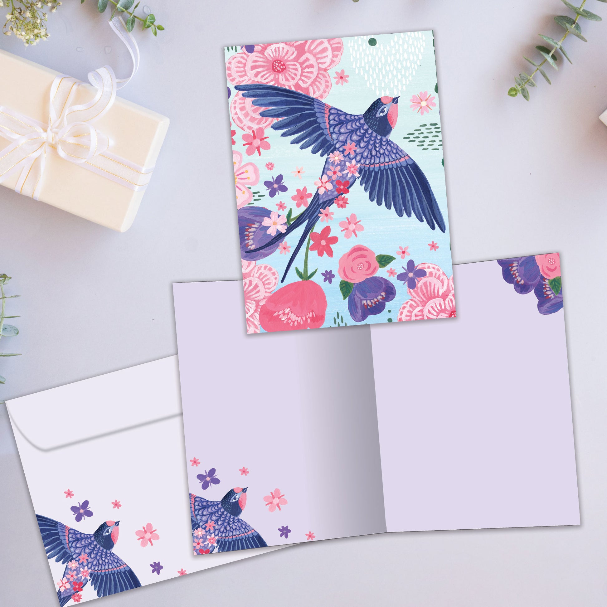 Front and inside view of an All Occasion greeting card showcasing a whimsical bird with floral design, with a matching envelope.