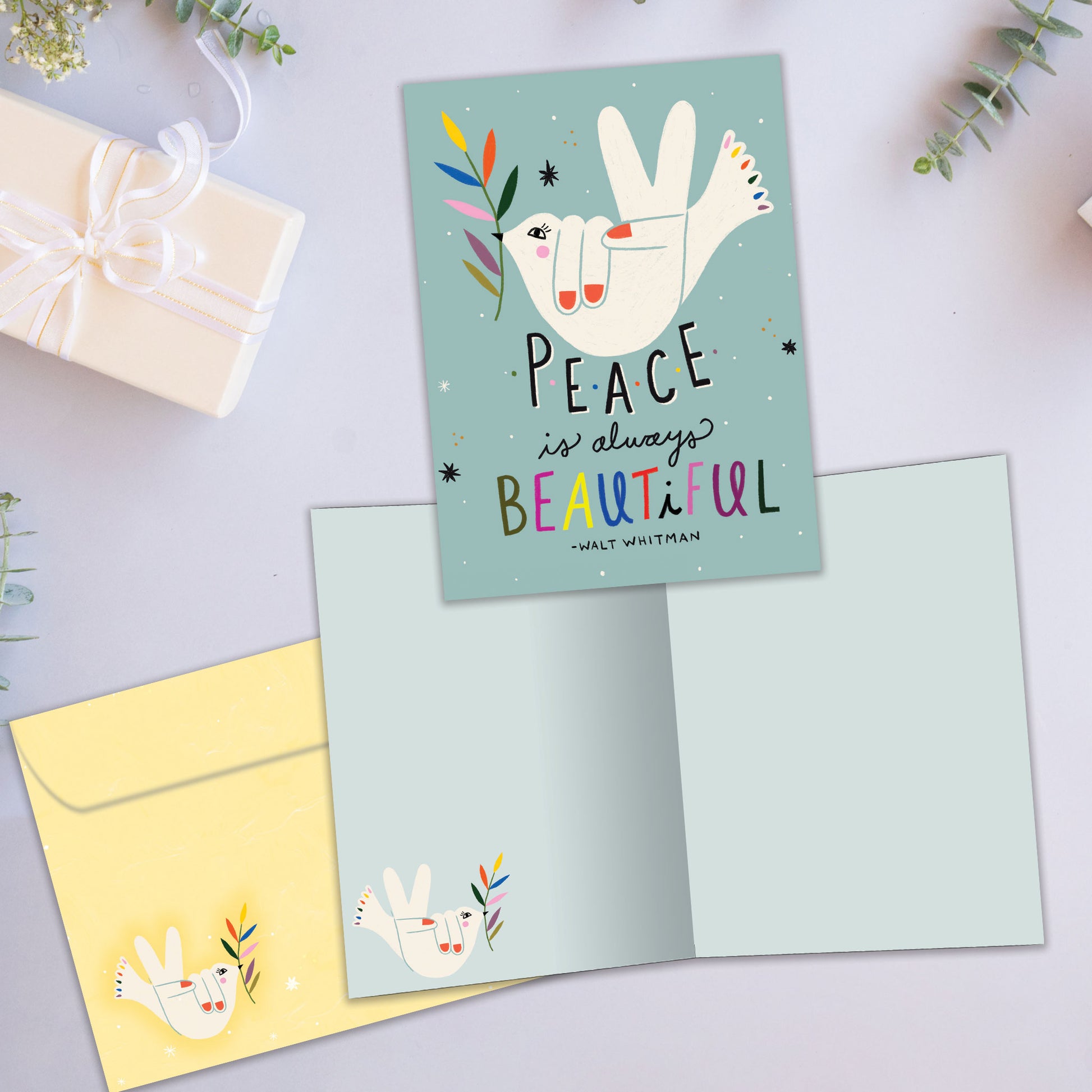 Front and inside view of an All Occasion greeting card featuring a bird illustration and the message 'Peace is always beautiful', plus a matching envelope.