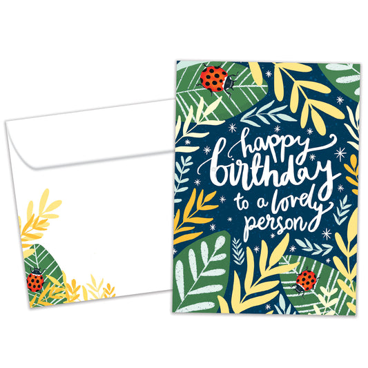 Front view of a Birthday greeting card featuring foliage and ladybugs surrounding a Happy Birthday message, with a matching envelope.
