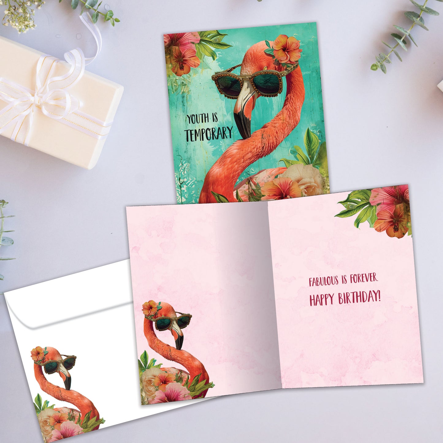 Front and inside view of a Birthday greeting card showcasing an illustration of a flamingo wearing sunglasses, with a matching envelope.