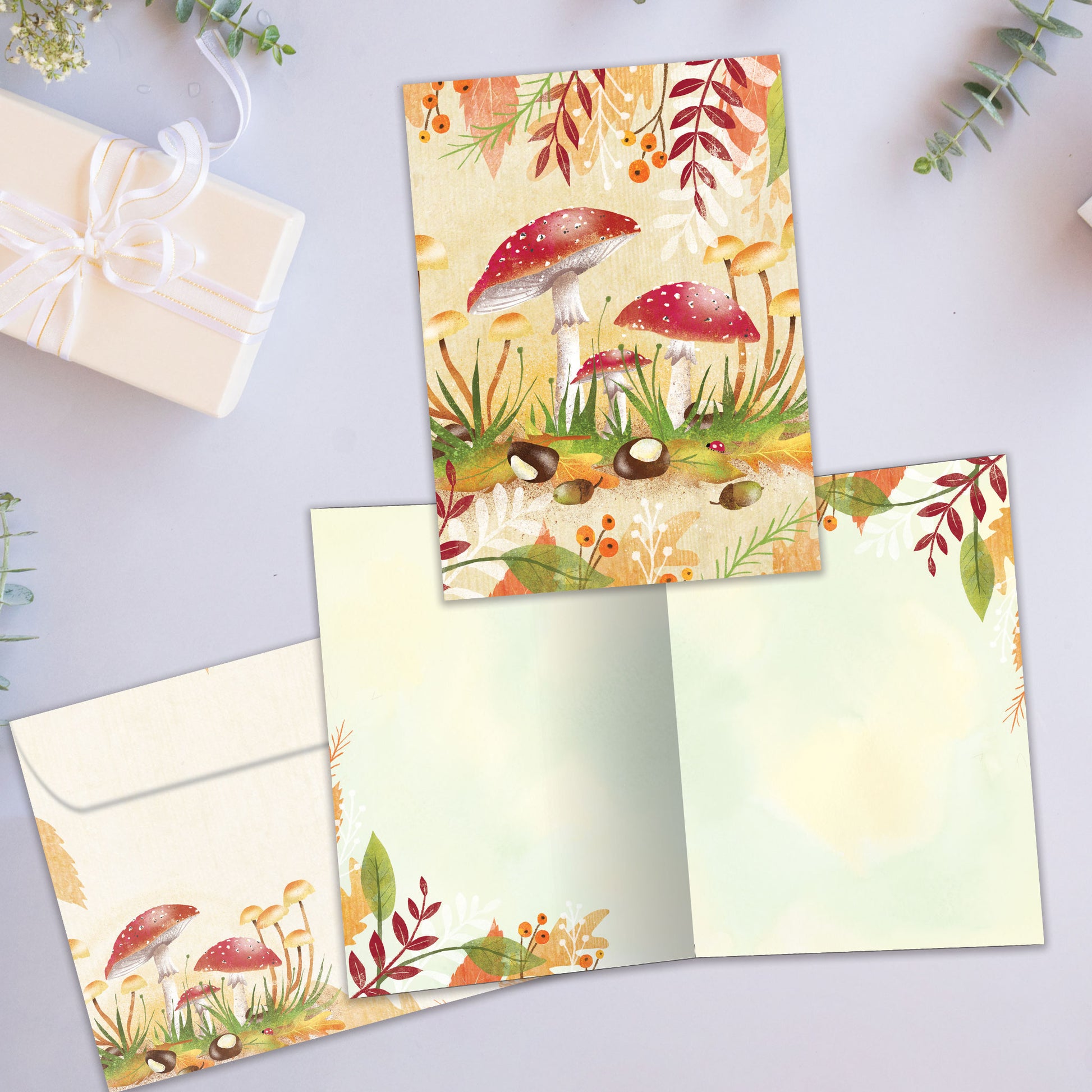 Front and inside view of an All Occasion greeting card featuring a lively forest scene with colourful mushrooms, plus a matching envelope.