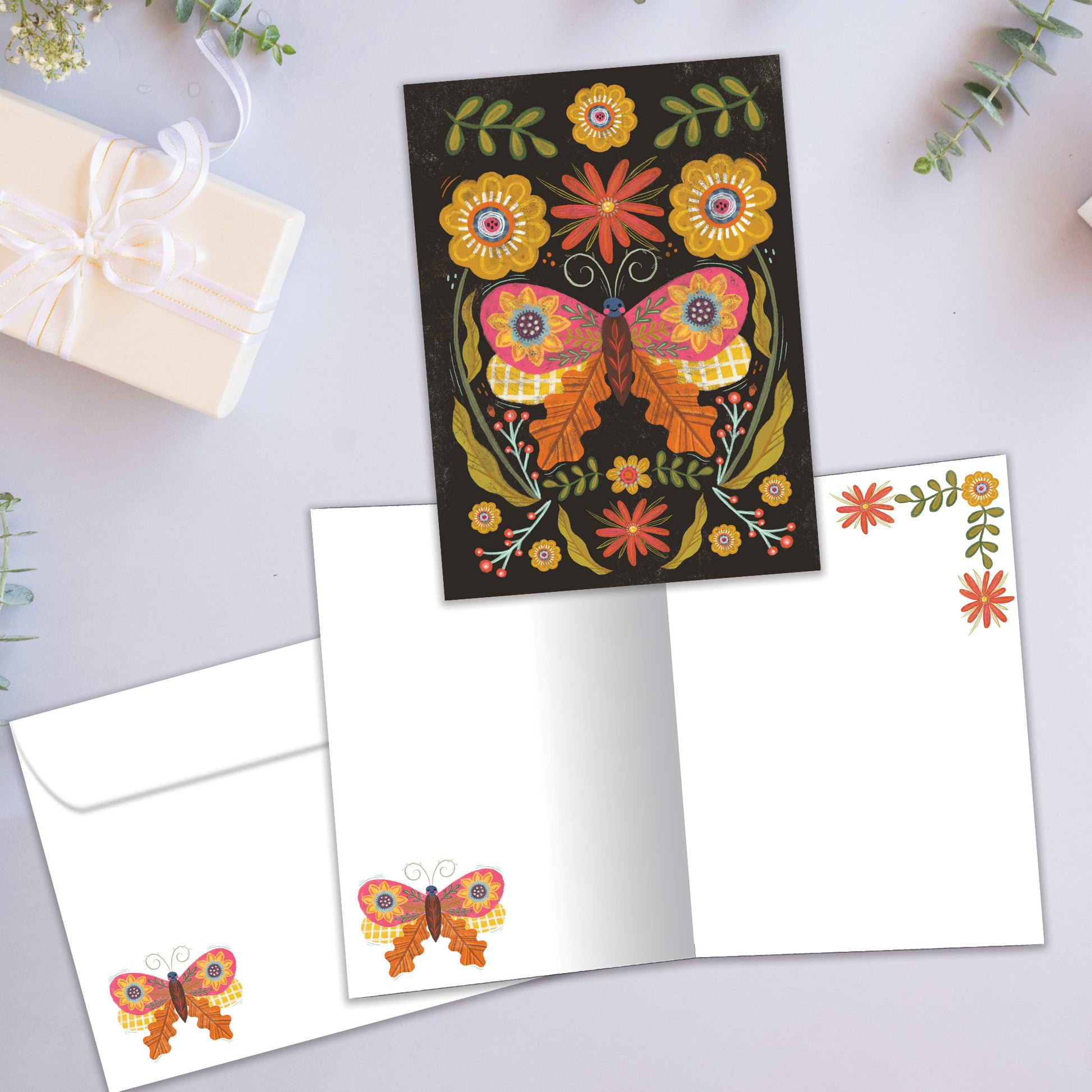 Front and inside view of an All Occasion greeting card featuring a butterfly with flowers on a dark background, plus a matching envelope.