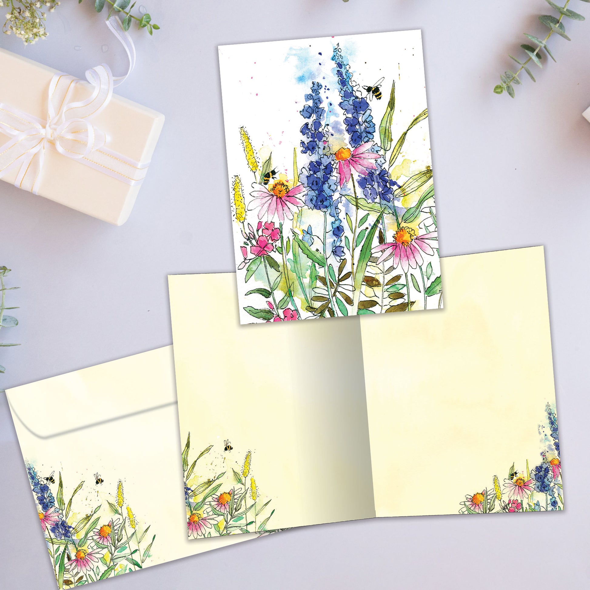 Front and inside view of an All Occasion greeting card with wildflowers and bees on a white background, plus matching envelope design.