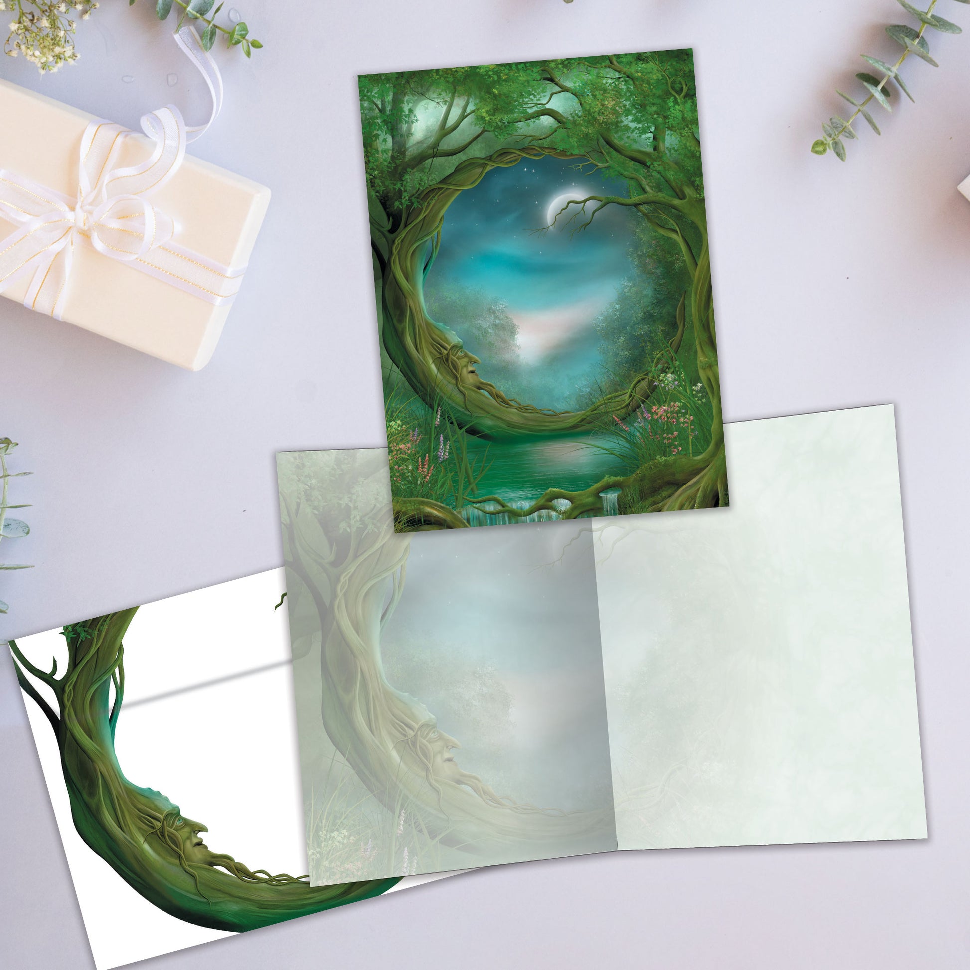 Front and inside view of an All Occasion greeting card showcasing a mystical forest with a prominent tree and magical surroundings, with matching envelope design.