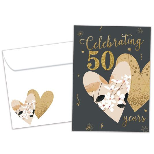 Front view of an Anniversary greeting card and matching envelope featuring "Celebrating 50 years" in gold on a dark background with two hearts.