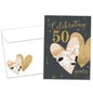 Front view of an Anniversary greeting card and matching envelope featuring "Celebrating 50 years" in gold on a dark background with two hearts.