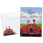 Front view of an Anniversary greeting card and matching envelope featuring a goose couple driving in a red car with a loving message.