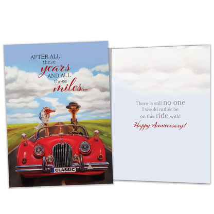 Front and inside view of an Anniversary greeting card featuring a goose couple driving in a red car with a loving message, with matching design details inside.