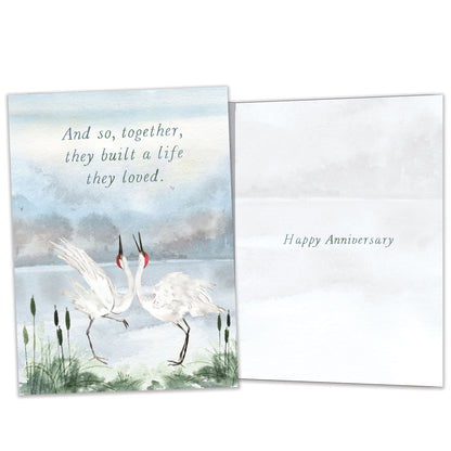 Front and inside view of an Anniversary greeting card featuring two cranes dancing together, with matching design details inside.