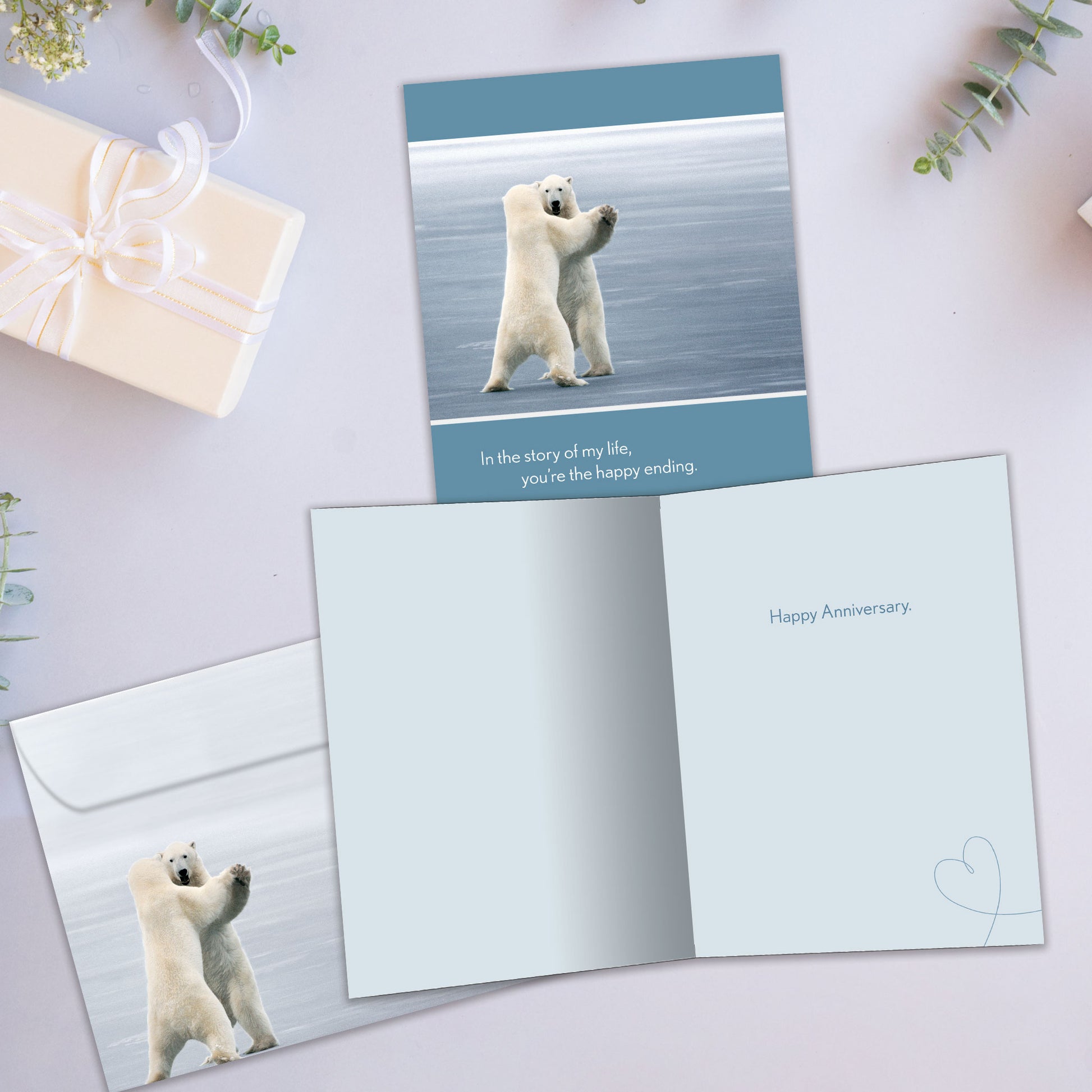 Front and inside view of an Anniversary greeting card showcasing two polar bears dancing with a loving message, with a matching envelope.