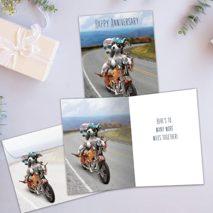 Front and inside view of an Anniversary greeting card showcasing two dogs on a motorcycle, with a matching envelope.