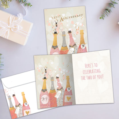 Front and inside view of an Anniversary greeting card showcasing champagne bottles with the words "Happy Anniversary," with a matching envelope.
