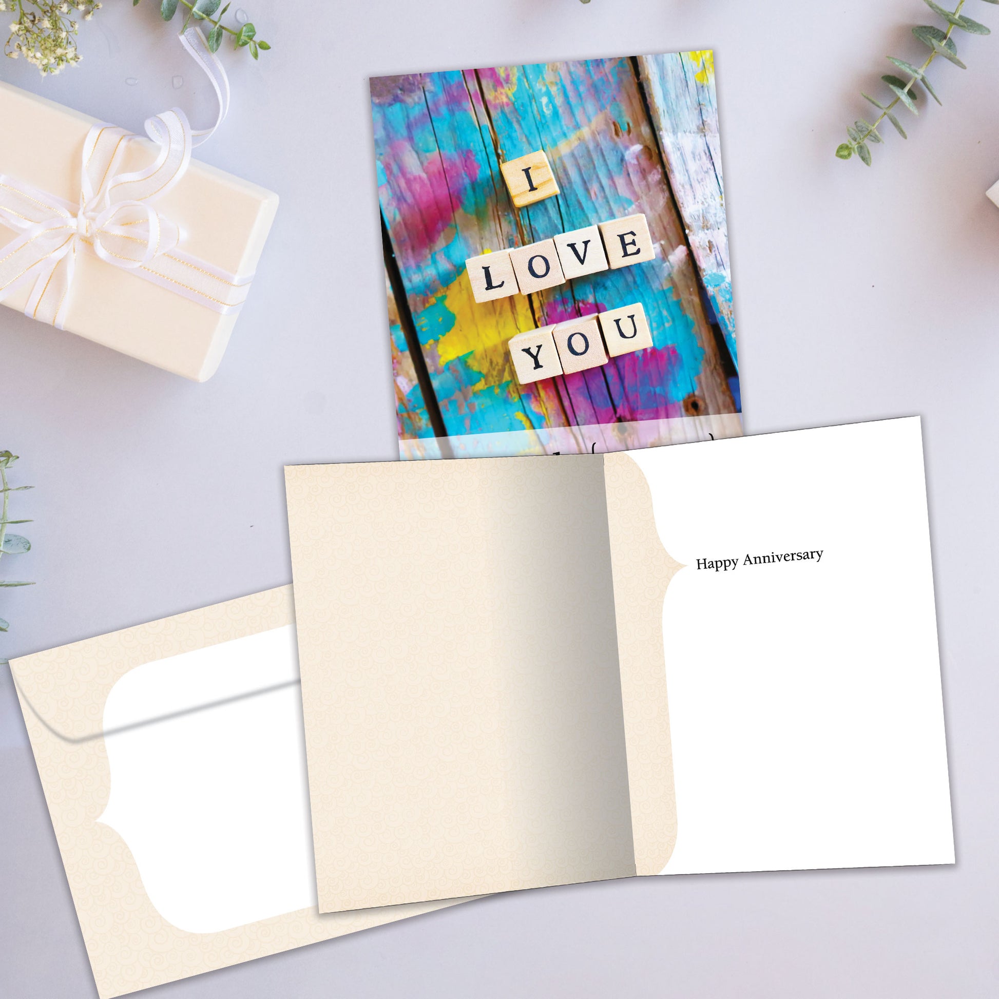 Front and inside view of an Anniversary greeting card showcasing the message "I love you" with the word "cherish," with a matching envelope.