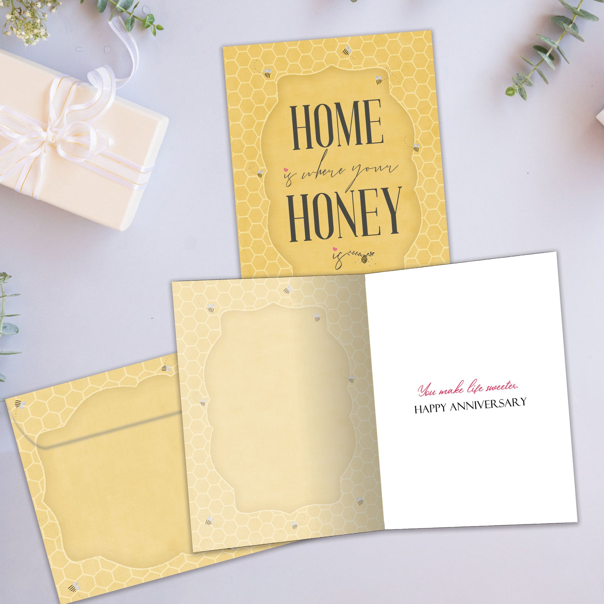 Front and inside view of an Anniversary greeting card showcasing a golden honeycomb background and a nice message, with a matching envelope.