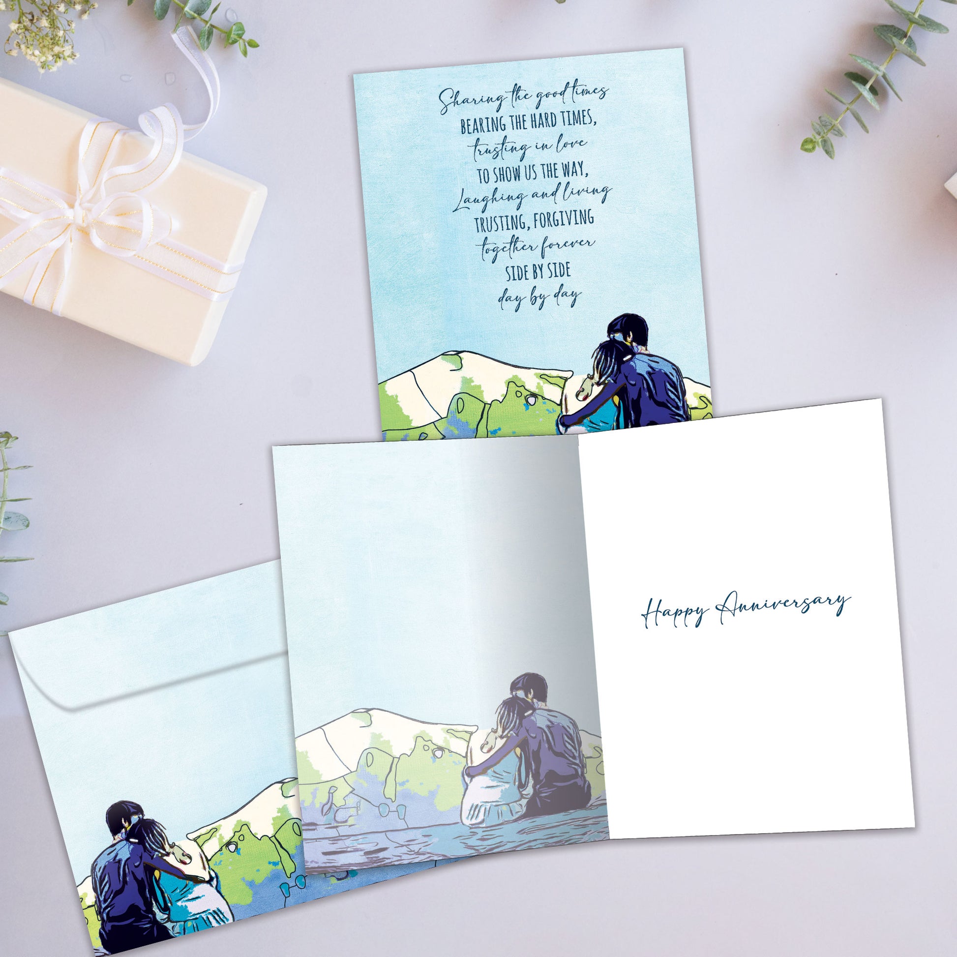 Front and inside view of an Anniversary greeting card showcasing an illustration of a caring couple with a loving message of togetherness, with a matching envelope.