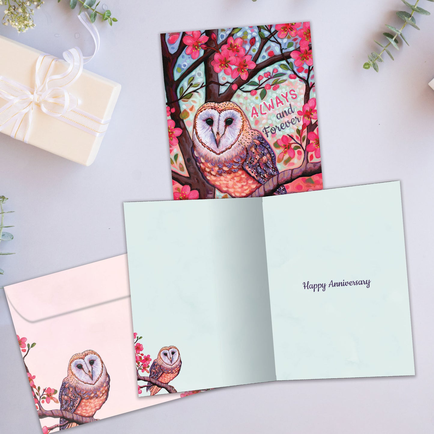 Front and inside view of an Anniversary greeting card showcasing a vibrant illustration of an owl with the words "Always and Forever," with a matching envelope.