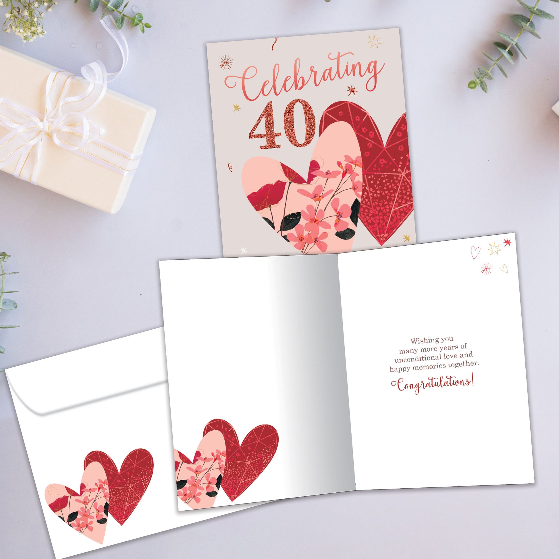 Front and inside view of an Anniversary greeting card showcasing "Celebrating 40 years" with two hearts, with a matching envelope.