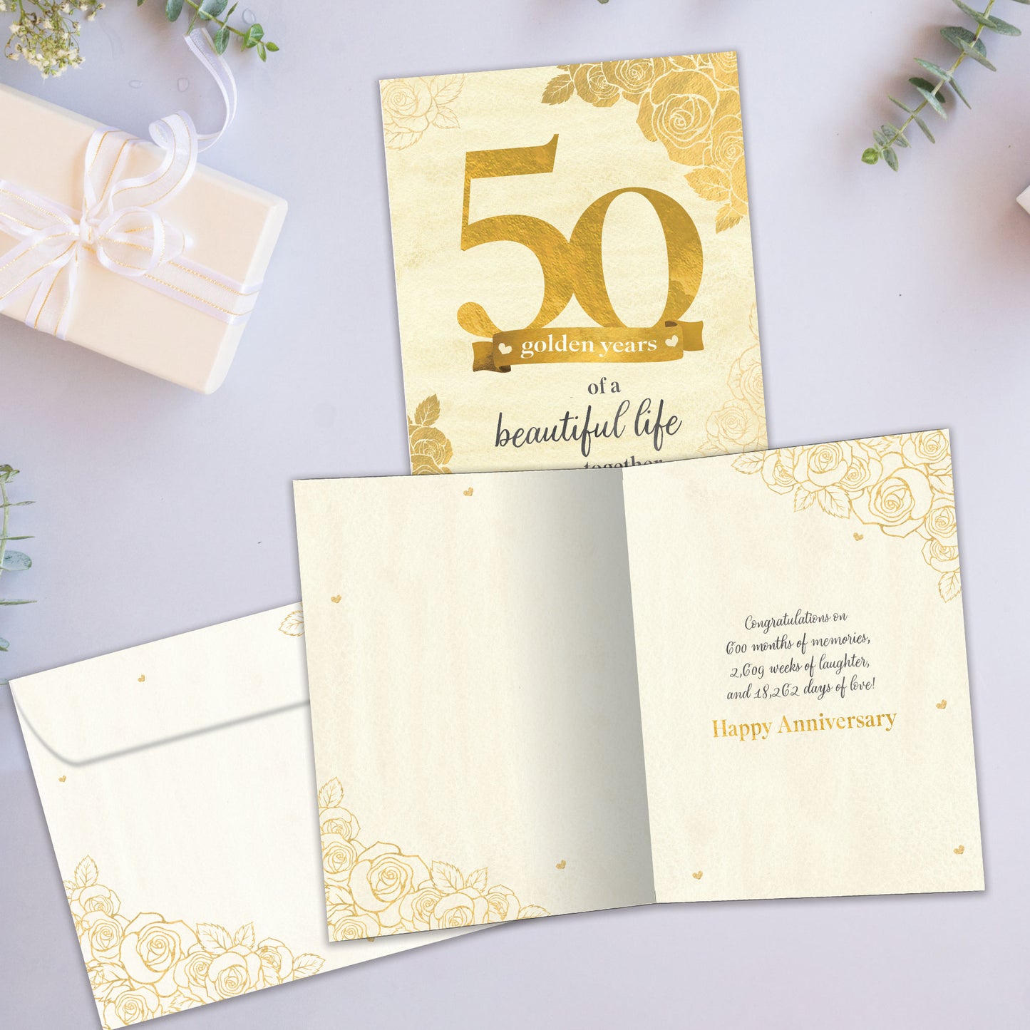Front and inside view of an Anniversary greeting card showcasing "50 golden years of a beautiful life together" in gold writing, with a matching envelope.