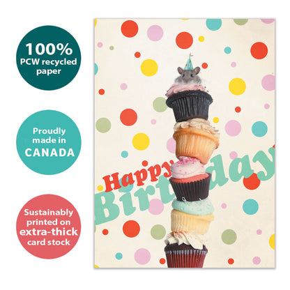 Front view of a Birthday greeting card with an illustration of stacked cupcakes and a mouse on top, highlighting its eco-friendly materials and made in Canada.