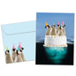 Front view of a Birthday greeting card and matching envelope featuring penguins floating atop a cake.