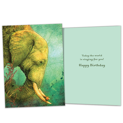 Front and inside view of a Birthday greeting card featuring an elephant with musical notes, with matching design details inside.