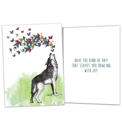 Front and inside view of a Birthday greeting card featuring a wolf howling butterflies, with matching design details inside.