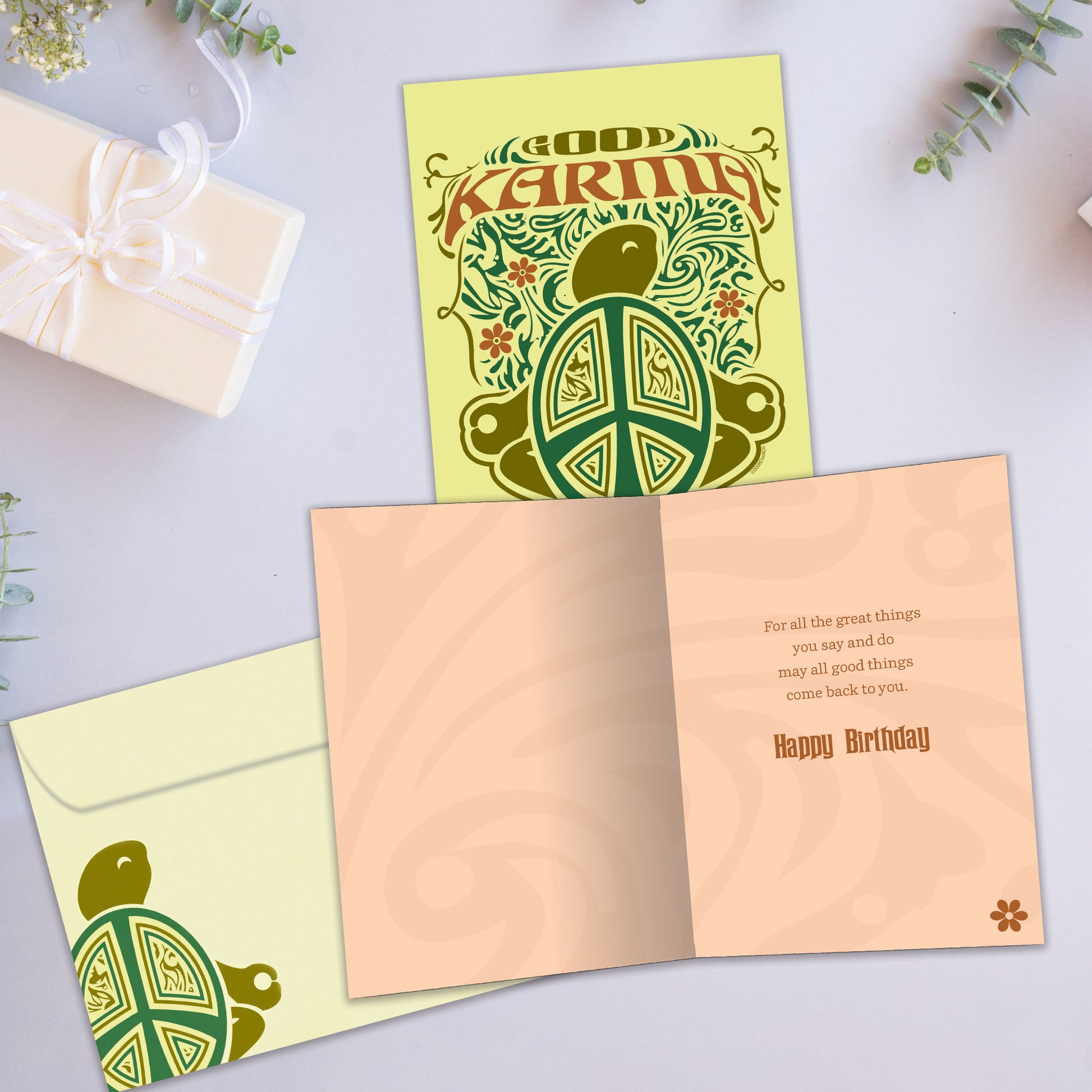 Front and inside view of a Birthday greeting card showcasing a green turtle illustration with "Good Karma," complete with a matching envelope.