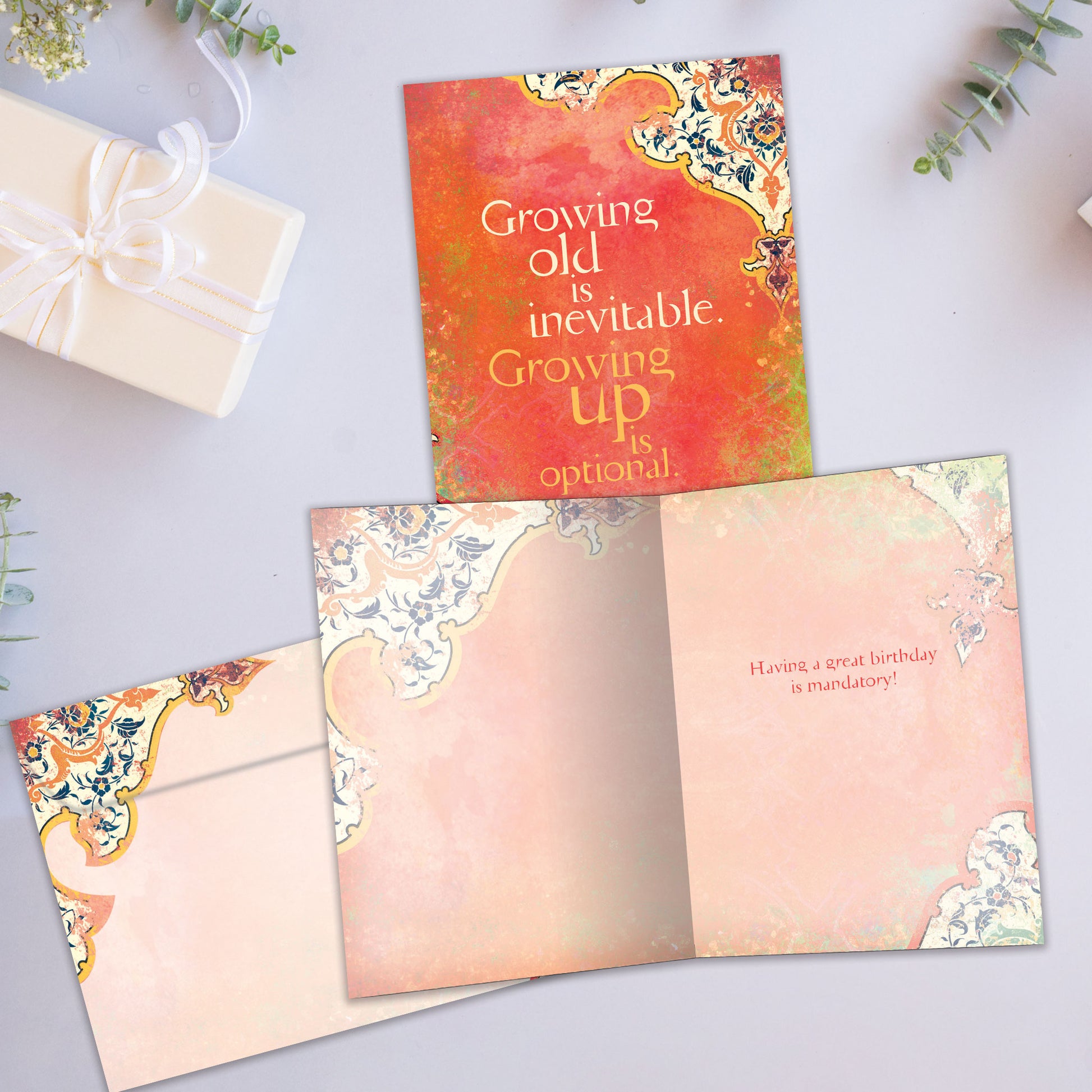 Front and inside view of a Birthday greeting card showcasing a message about growing older on an artistic background, with a matching envelope.