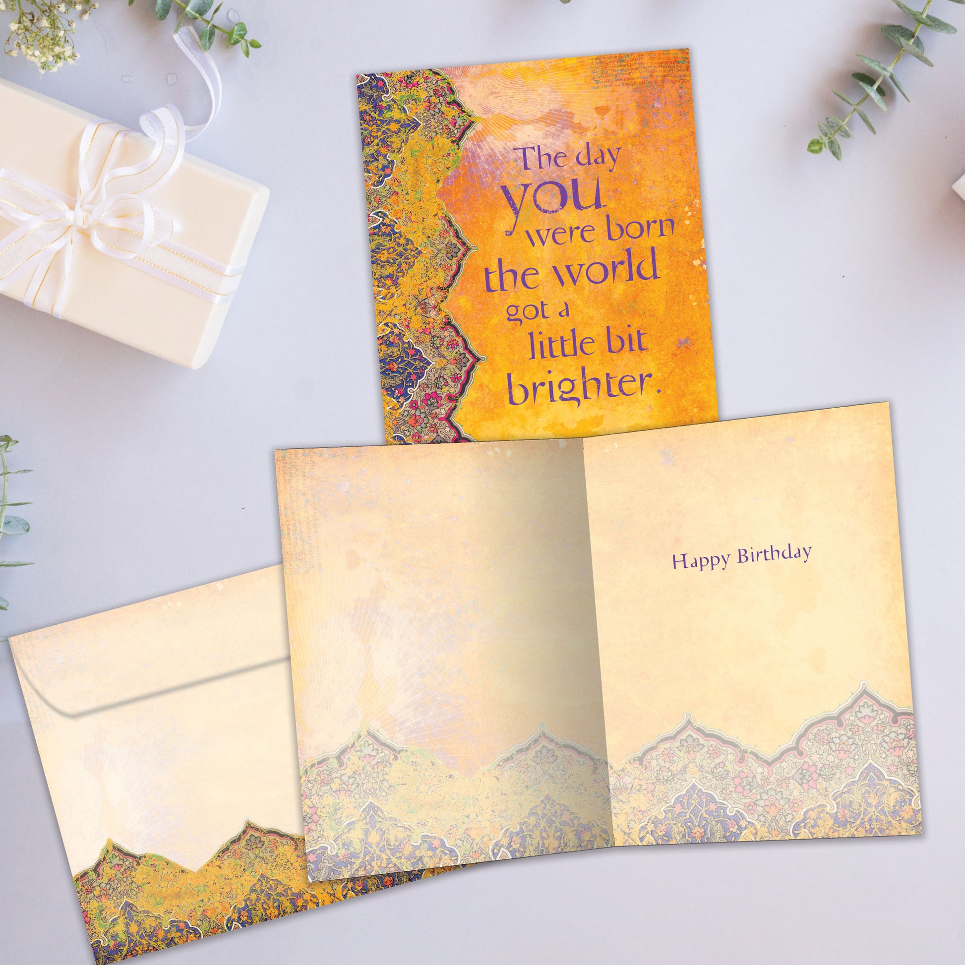 Front and inside view of a Birthday greeting card showcasing a thoughtful message on an artistic amber background, with a matching envelope.