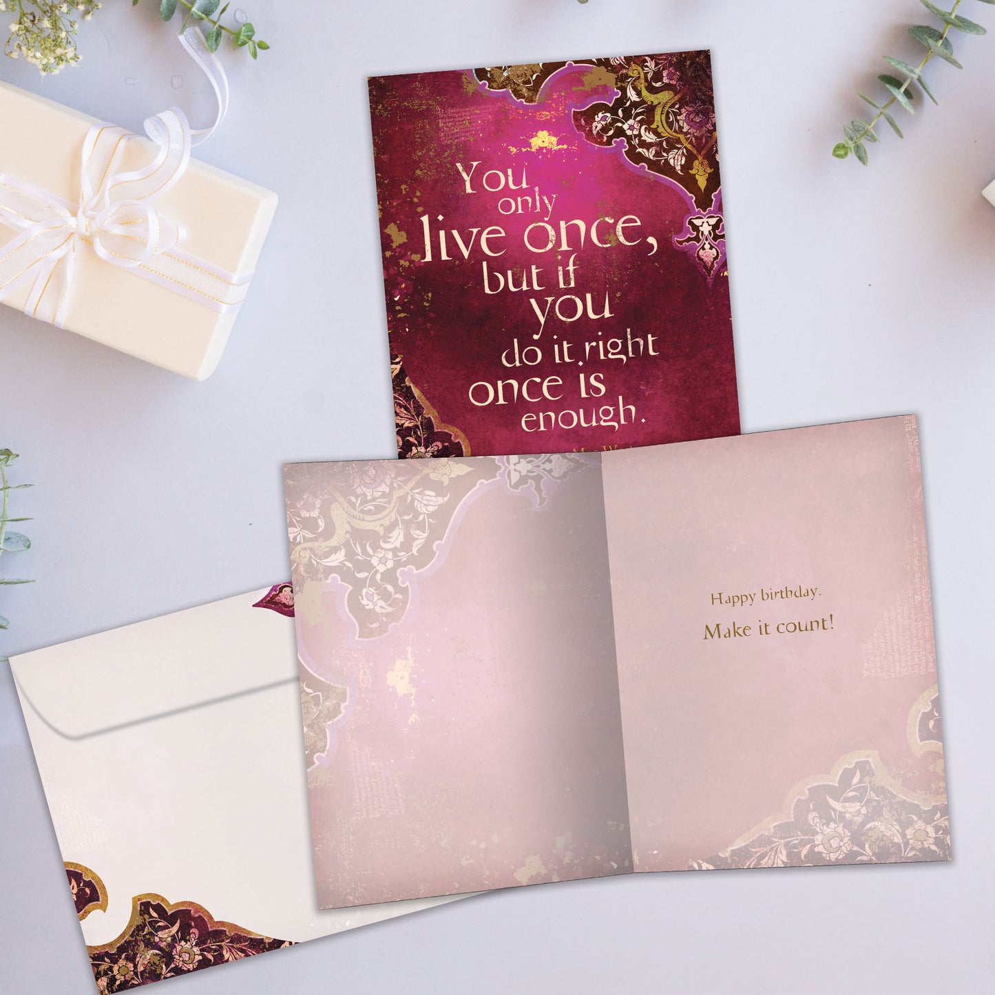Front and inside view of a Birthday greeting card showcasing an inspiring message about living life on a wine coloured background, with a matching envelope.