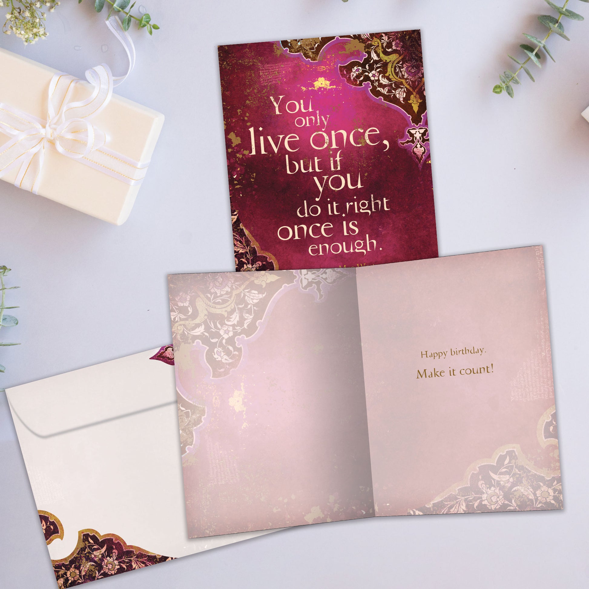Front and inside view of a Birthday greeting card showcasing an inspiring message about living life on a wine coloured background, with a matching envelope.