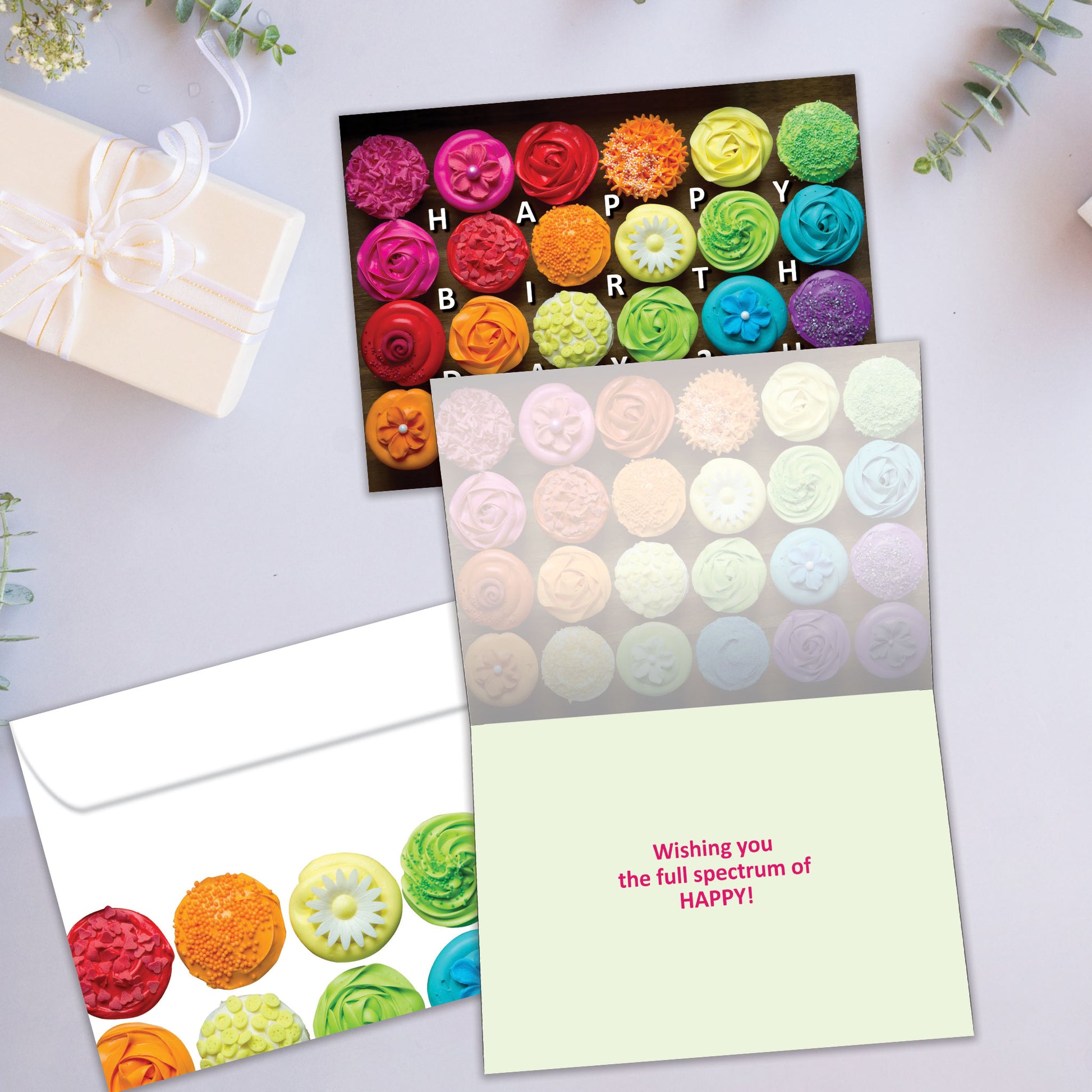 Front and inside view of a Birthday greeting card showcasing the message "Happy Birthday 2 U" with vibrant cupcakes on a black background, with a matching envelope.