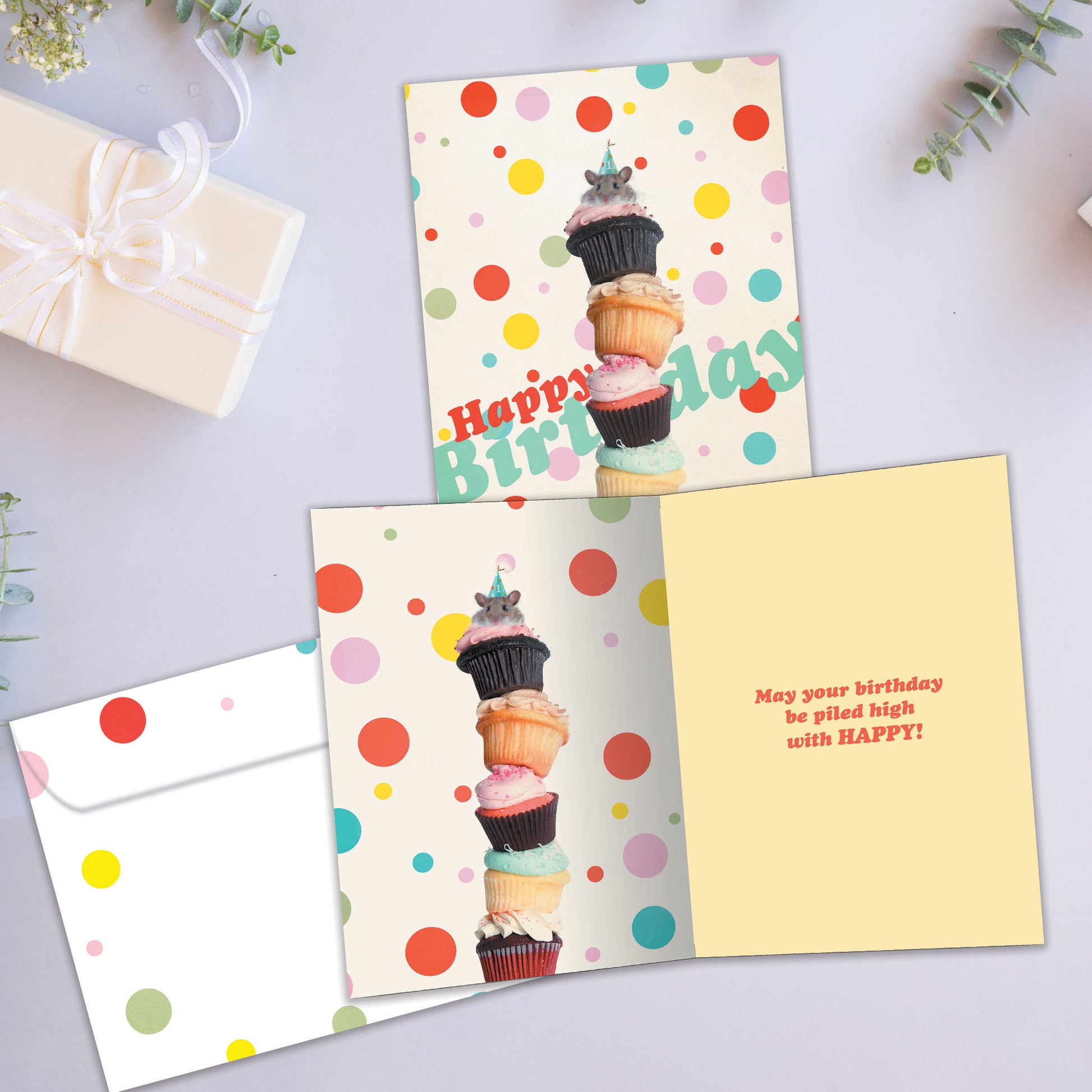 Front and inside view of a Birthday greeting card showcasing an image of stacked cupcakes with a mouse on top, with a matching envelope.