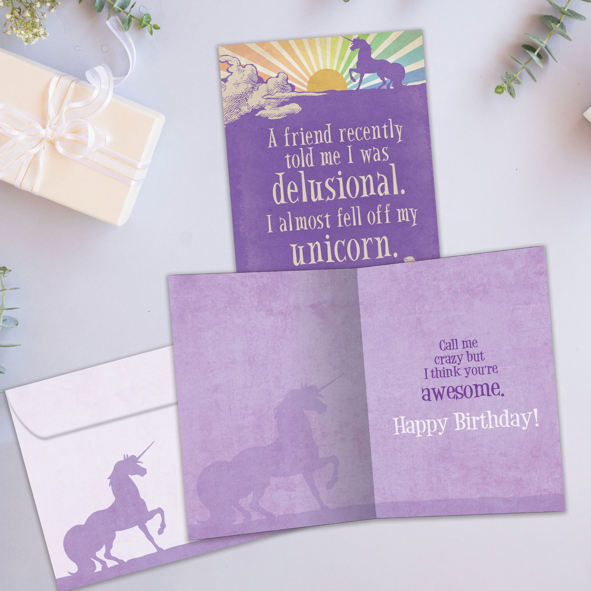 Front and inside view of a Birthday greeting card showcasing a unicorn illustration with a funny message, with a matching envelope.