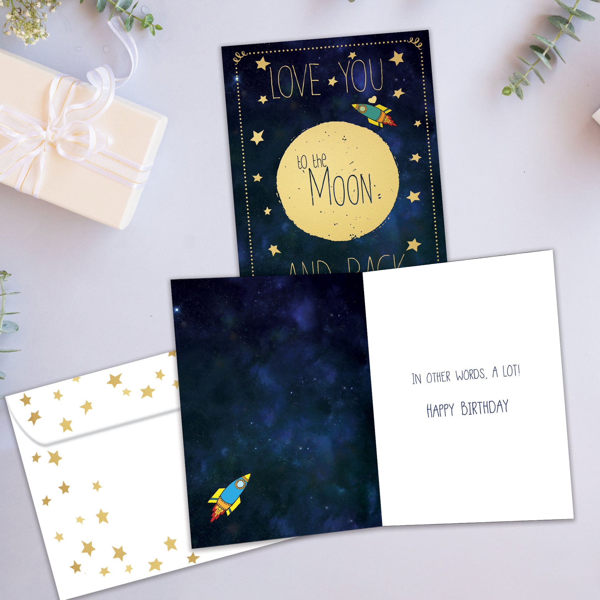 Front and inside view of a Birthday greeting card showcasing the message "Love you to the moon and back," with a matching envelope.