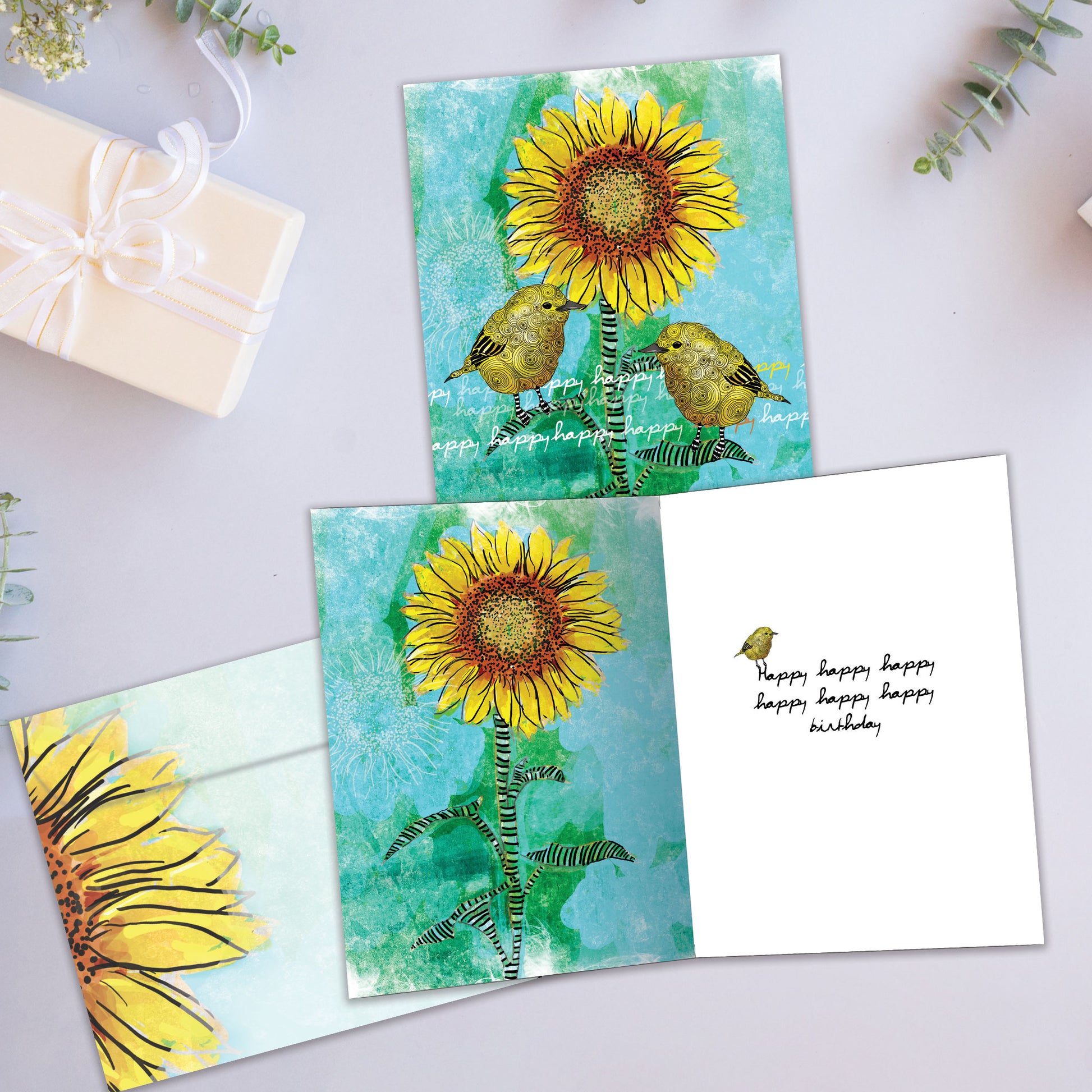 Front and inside view of a Birthday greeting card showcasing two birds on a sunflower, with a matching envelope.