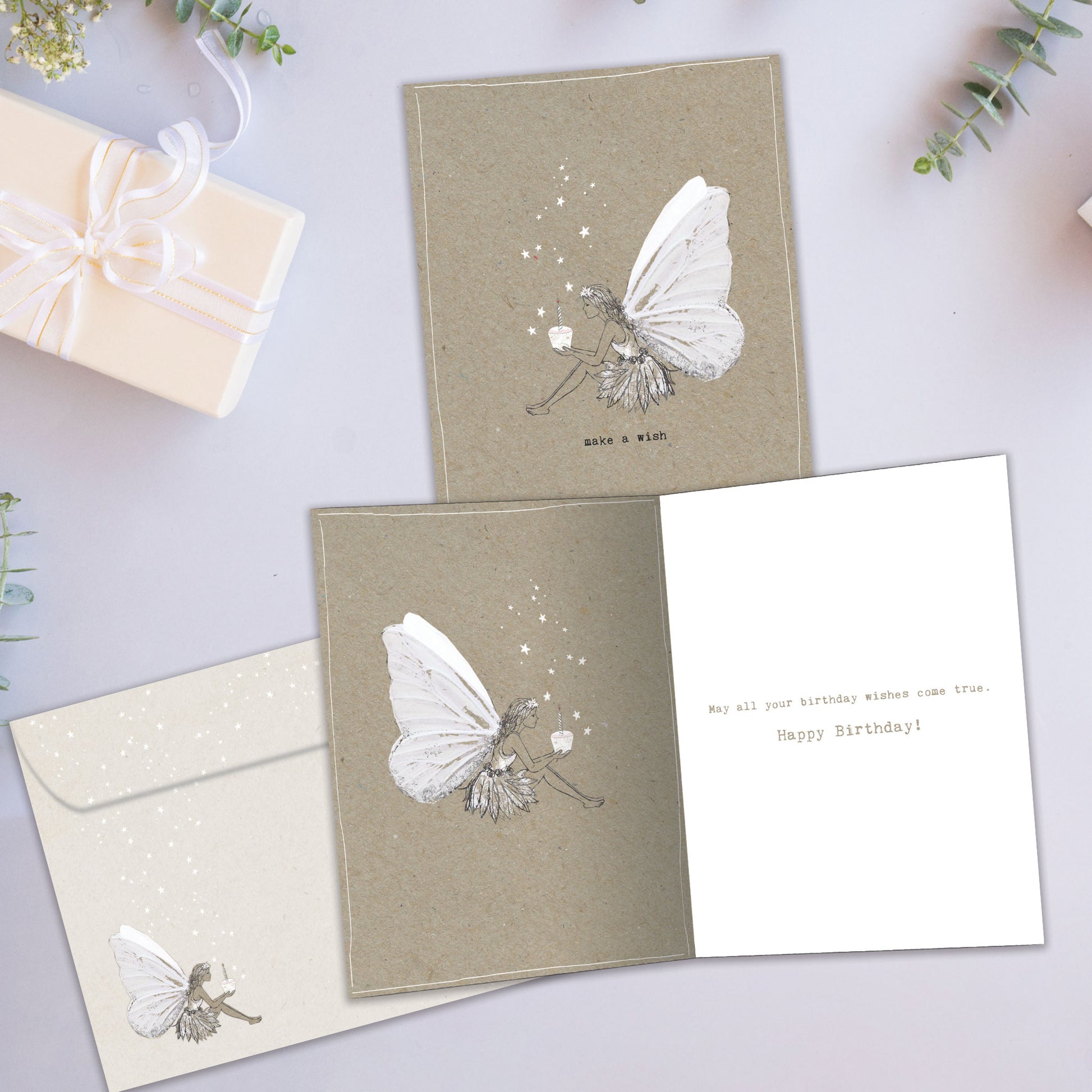 Front and inside view of a Birthday greeting card showcasing a dainty fairy illustration with the message "make a wish," with a matching envelope.